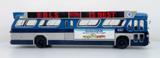 A scale model of a vintage blue and silver bus with a red and black advert reading 'BLS IS BEST' and a Chevrolet advertisement on the side, shown against a plain white background.