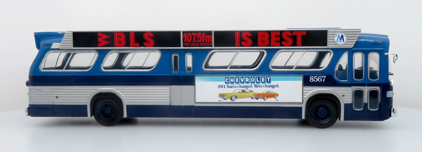 A scale model of a vintage blue and silver bus with a red and black advert reading 'BLS IS BEST' and a Chevrolet advertisement on the side, shown against a plain white background.