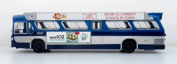 A scale model of a vintage blue and white bus, featuring printed advertisements on its side, photographed against a clean white background.